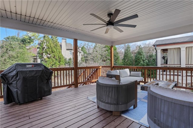 wooden terrace featuring an outdoor hangout area, ceiling fan, and grilling area