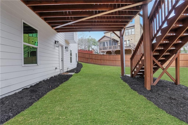 view of yard with stairs and fence