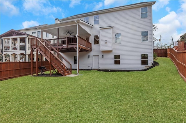 back of property featuring stairs, a lawn, a fenced backyard, and a ceiling fan