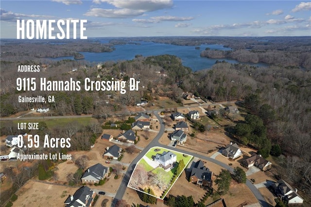 birds eye view of property with a forest view and a water view