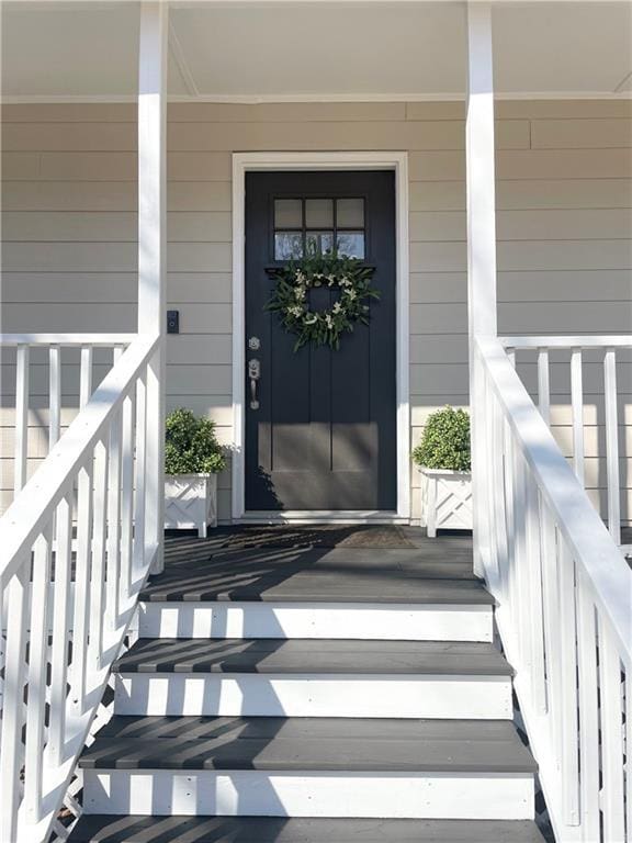 doorway to property featuring covered porch