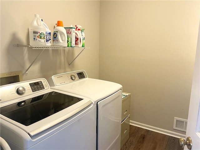 laundry room featuring dark wood-type flooring and washing machine and clothes dryer