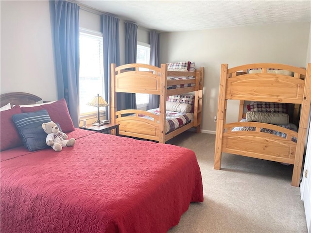 bedroom with carpet floors and a textured ceiling