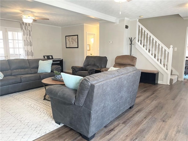 living room featuring crown molding, ceiling fan, wood-type flooring, and a textured ceiling