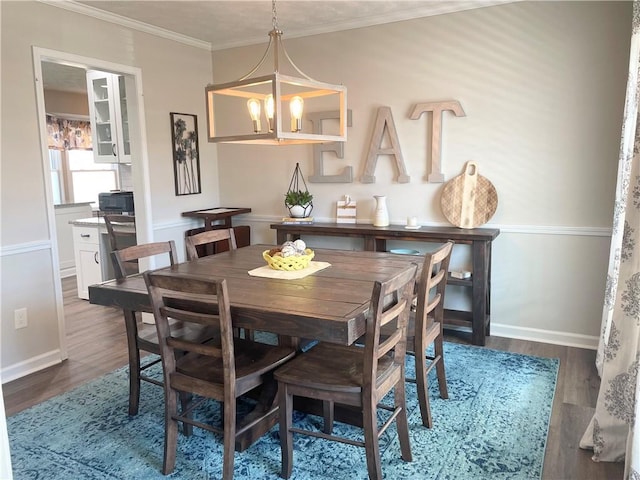 dining room with crown molding, a chandelier, and hardwood / wood-style floors