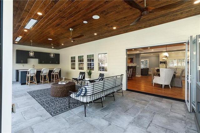 interior space featuring a ceiling fan, recessed lighting, and wooden ceiling