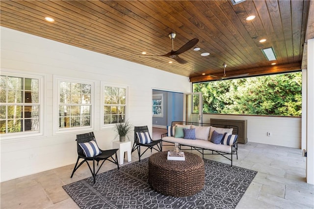 sunroom / solarium with wooden ceiling and ceiling fan