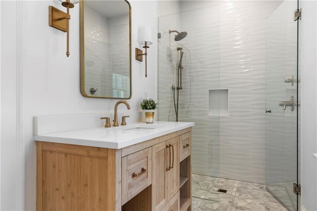 bathroom featuring a shower stall and vanity