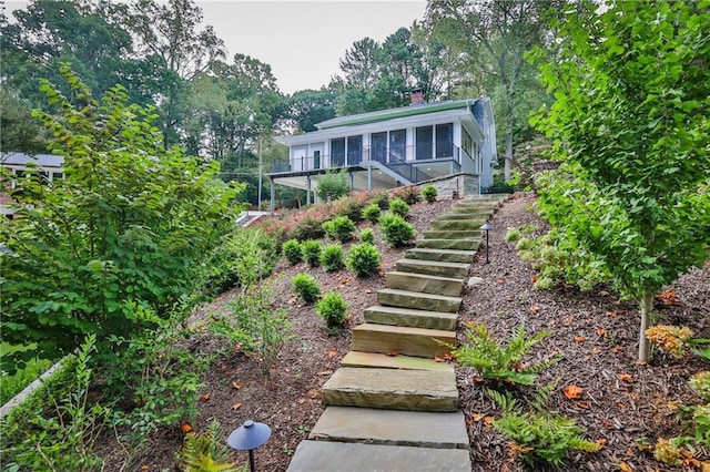 view of front of property featuring a chimney and stairway