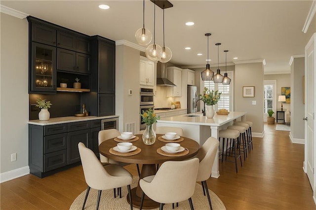 146 Rowan Ave, Alpharetta, GA 30009 - dining space with baseboards, ornamental molding, recessed lighting, and wood finished floors