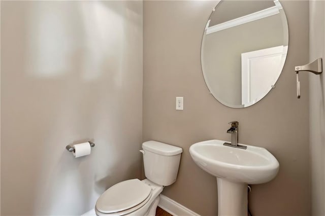 146 Rowan Ave, Alpharetta, GA 30009 - bathroom with crown molding, toilet, baseboards, and a sink