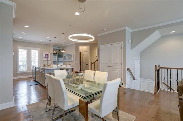 dining area featuring ornamental molding, wainscoting, wood finished floors, and recessed lighting