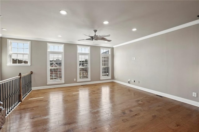 empty room with recessed lighting, visible vents, ornamental molding, baseboards, and hardwood / wood-style flooring