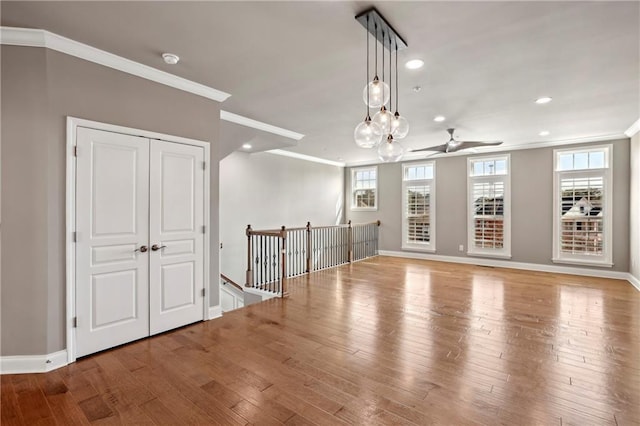 unfurnished room featuring hardwood / wood-style flooring, baseboards, and ornamental molding