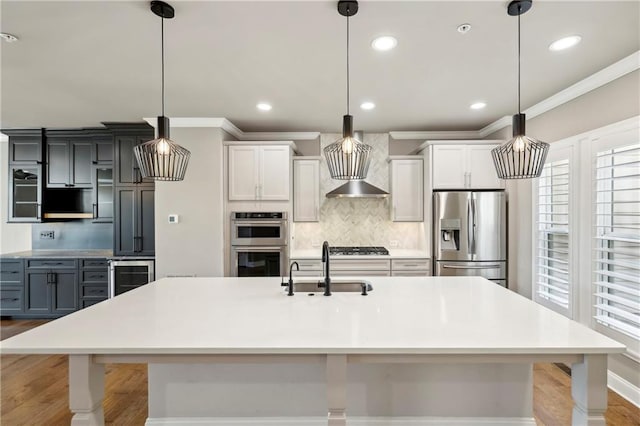 kitchen featuring wine cooler, decorative backsplash, appliances with stainless steel finishes, ornamental molding, and a sink