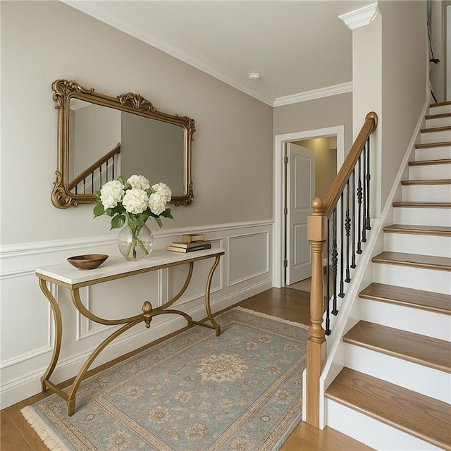 146 Rowan Ave, Alpharetta, GA 30009 - stairs featuring ornamental molding, a decorative wall, a wainscoted wall, and wood finished floors