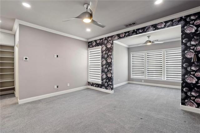 carpeted spare room with visible vents, baseboards, ceiling fan, ornamental molding, and recessed lighting