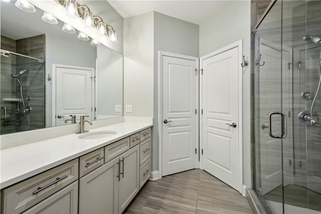 full bath with a shower stall and vanity