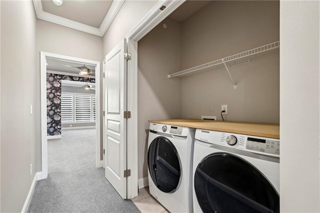 laundry room featuring crown molding, washing machine and dryer, light carpet, laundry area, and baseboards