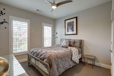 bedroom featuring a ceiling fan, visible vents, and baseboards