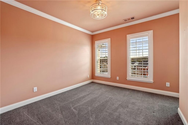 unfurnished room featuring baseboards, dark carpet, visible vents, and crown molding