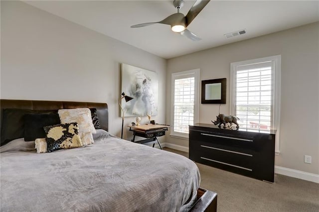 bedroom featuring ceiling fan, carpet flooring, visible vents, and baseboards