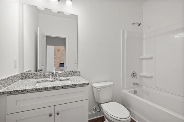 full bathroom featuring toilet, vanity, baseboards, and washtub / shower combination