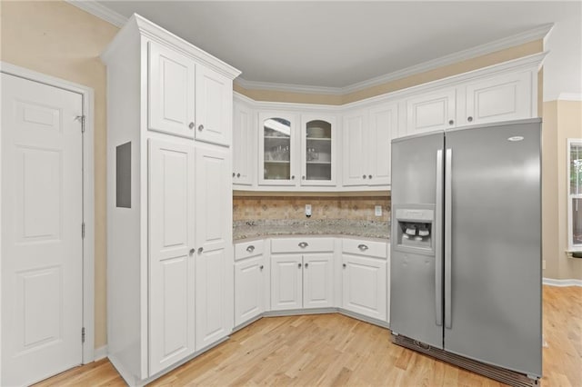 kitchen featuring light stone counters, light hardwood / wood-style floors, stainless steel fridge with ice dispenser, and white cabinets