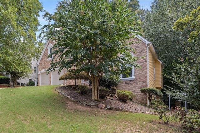 view of property exterior with a garage and a yard