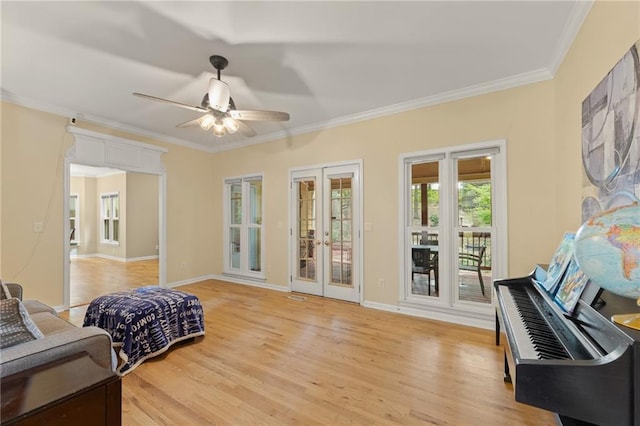 interior space with french doors, ceiling fan, ornamental molding, and light hardwood / wood-style floors