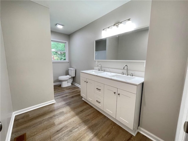 336 Shady Lane Cir, Canton, GA 30115 - full bathroom with toilet, double vanity, wood finished floors, and baseboards