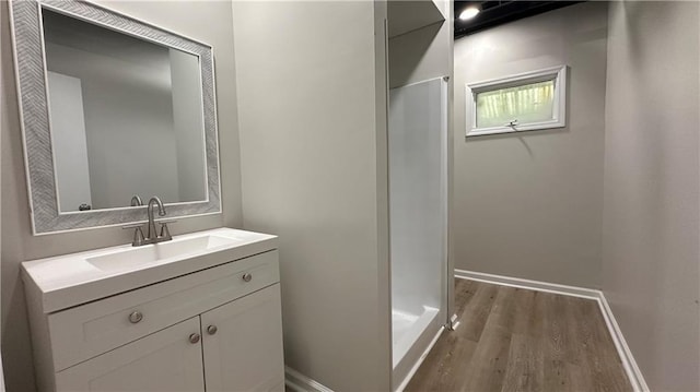 336 Shady Lane Cir, Canton, GA 30115 - full bathroom featuring wood finished floors, baseboards, a shower stall, and vanity