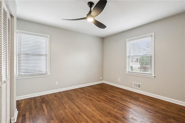 unfurnished room featuring ceiling fan and dark hardwood / wood-style floors