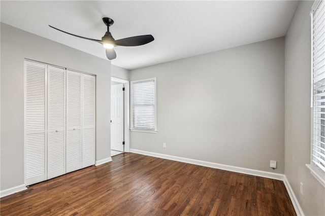 unfurnished bedroom featuring dark hardwood / wood-style floors, a closet, and ceiling fan