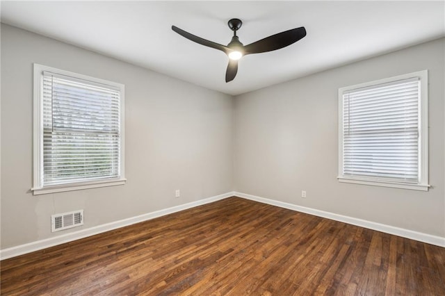 empty room featuring dark hardwood / wood-style flooring and ceiling fan