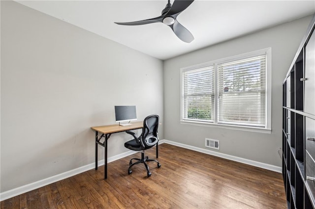 office with dark wood-type flooring and ceiling fan