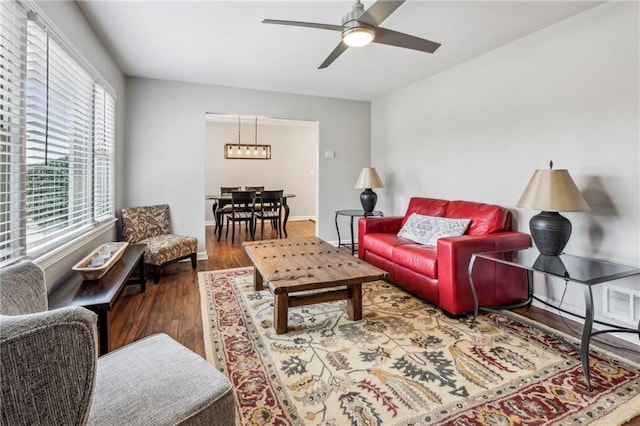 living room with wood-type flooring and ceiling fan