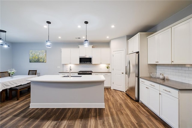 5440 Wheeler Ridge Rd, Auburn, GA 30011 - kitchen with stainless steel appliances, backsplash, dark wood-style floors, a sink, and recessed lighting