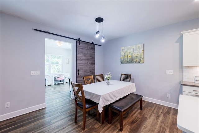 5440 Wheeler Ridge Rd, Auburn, GA 30011 - dining area featuring a barn door, dark wood-style flooring, and baseboards