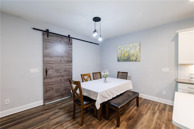5440 Wheeler Ridge Rd, Auburn, GA 30011 - dining space with a barn door, dark wood-style floors, and baseboards