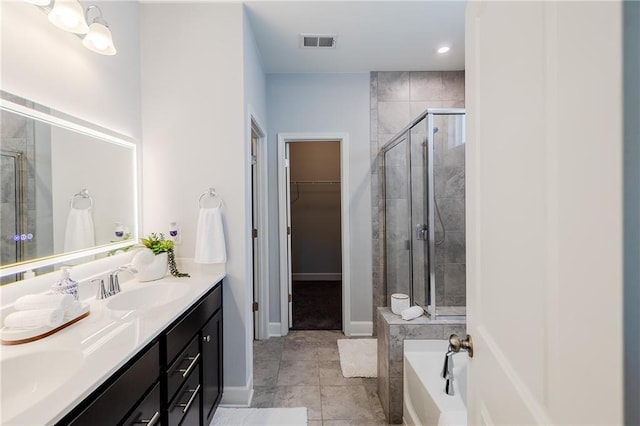 5440 Wheeler Ridge Rd, Auburn, GA 30011 - bathroom with double vanity, a shower stall, a bath, a spacious closet, and recessed lighting