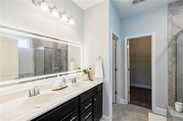 5440 Wheeler Ridge Rd, Auburn, GA 30011 - full bathroom with a stall shower, a spacious closet, double vanity, and tile patterned flooring
