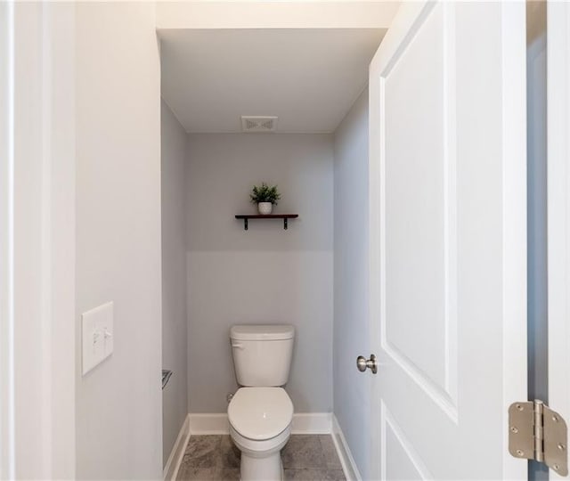 5440 Wheeler Ridge Rd, Auburn, GA 30011 - bathroom featuring baseboards, toilet, and tile patterned flooring