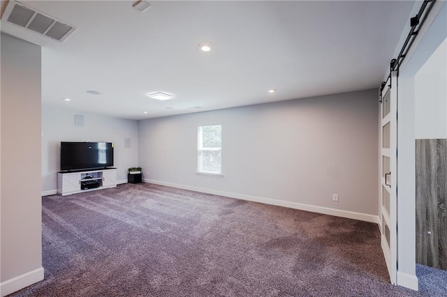 5440 Wheeler Ridge Rd, Auburn, GA 30011 - unfurnished living room featuring a barn door, carpet flooring, baseboards, and recessed lighting