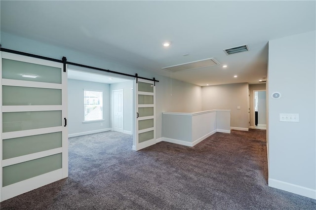 5440 Wheeler Ridge Rd, Auburn, GA 30011 - empty room featuring dark carpet, attic access, a barn door, recessed lighting, and baseboards