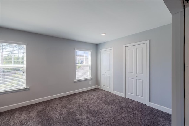 5440 Wheeler Ridge Rd, Auburn, GA 30011 - unfurnished bedroom featuring multiple closets, carpet floors, baseboards, and recessed lighting
