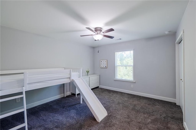 5440 Wheeler Ridge Rd, Auburn, GA 30011 - unfurnished bedroom featuring dark carpet, baseboards, ceiling fan, and an office area