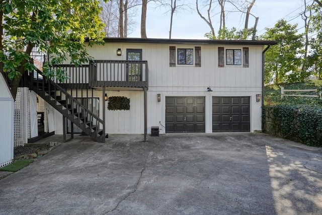 view of front of property with central AC unit and a garage