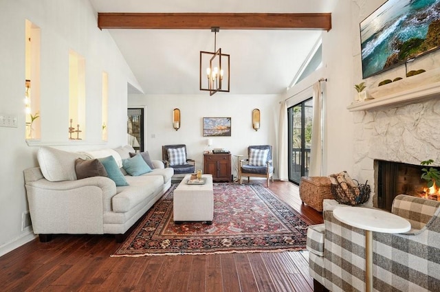 living room featuring vaulted ceiling with beams, dark hardwood / wood-style flooring, and a stone fireplace