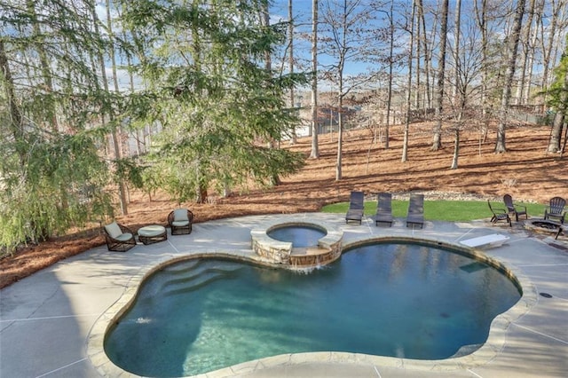 view of pool with an outdoor fire pit, a patio area, and a pool with connected hot tub